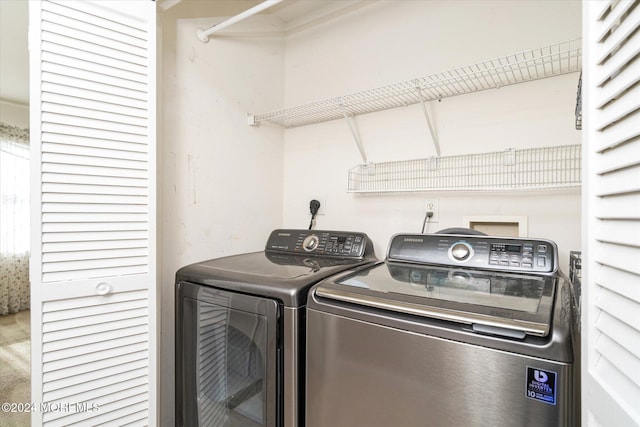 clothes washing area featuring independent washer and dryer