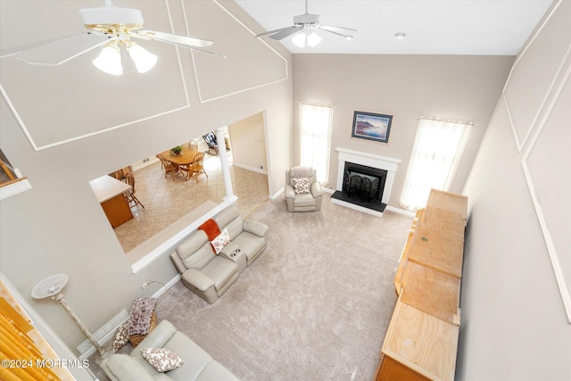 living room featuring carpet flooring, high vaulted ceiling, and ceiling fan