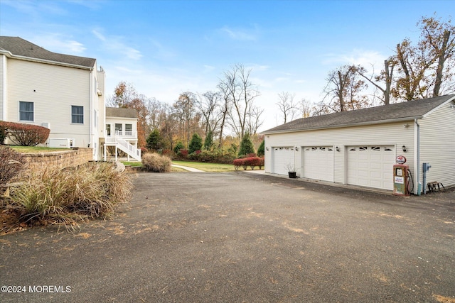 24 Clearwater Dr, Allentown, NJ 08501 - view of side of property featuring stairway, a garage, and asphalt driveway