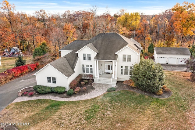 24 Clearwater Dr, Allentown, NJ 08501 - view of front of home with a front yard, an outbuilding, a shingled roof, and a porch