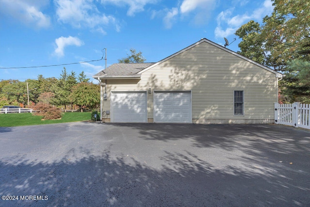 view of side of home with a garage