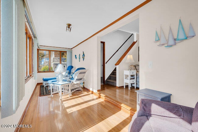 living room featuring crown molding and hardwood / wood-style flooring