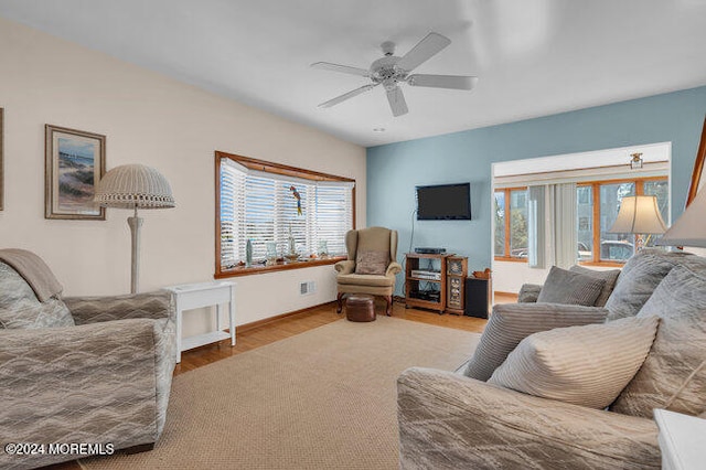 living room featuring ceiling fan, hardwood / wood-style flooring, and a wealth of natural light