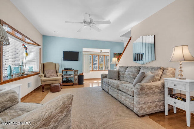 living room with light hardwood / wood-style floors and ceiling fan