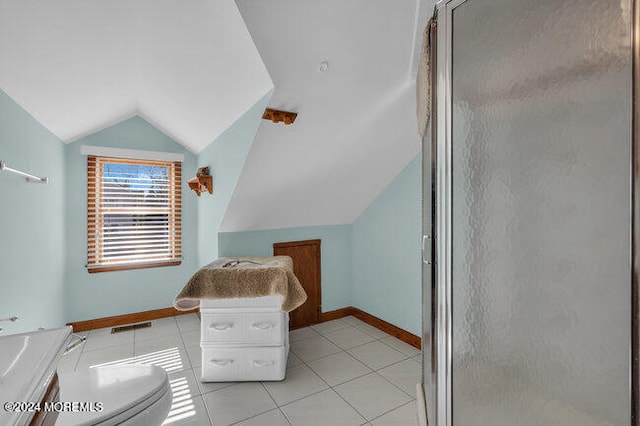 bathroom with tile patterned floors, toilet, a shower with shower door, vaulted ceiling, and vanity