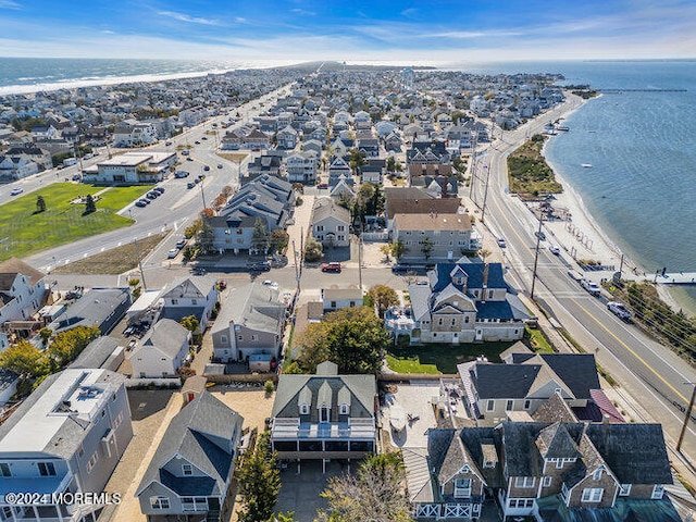 birds eye view of property with a view of the beach and a water view