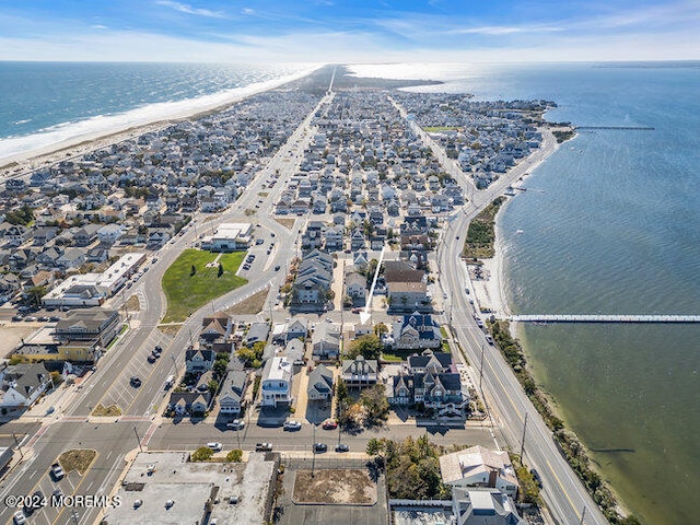 birds eye view of property with a water view and a view of the beach