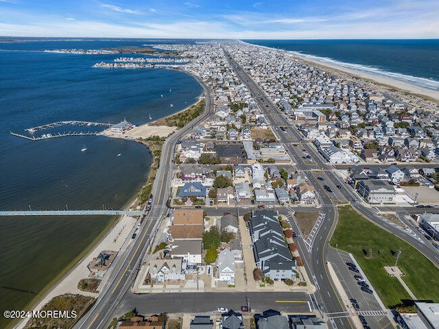 drone / aerial view with a water view and a view of the beach