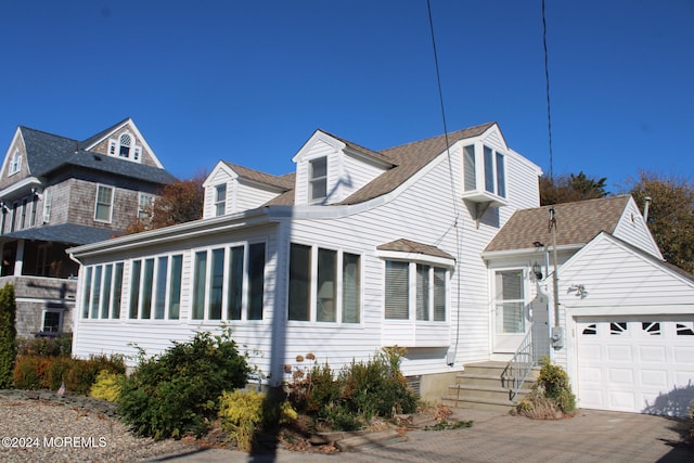 cape cod-style house with a garage