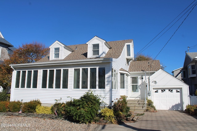 new england style home with a garage