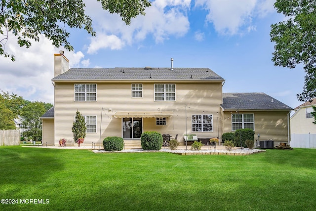 back of property featuring central AC unit, a patio area, and a lawn