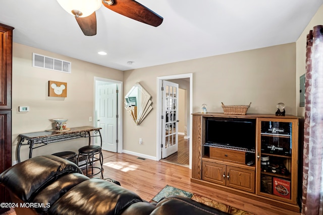 living room with ceiling fan and light hardwood / wood-style floors