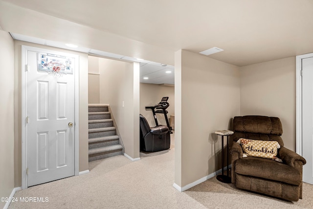 living area featuring light carpet