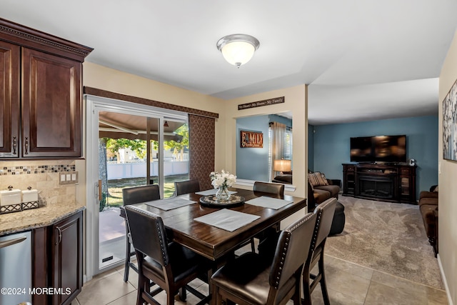 dining area featuring light carpet