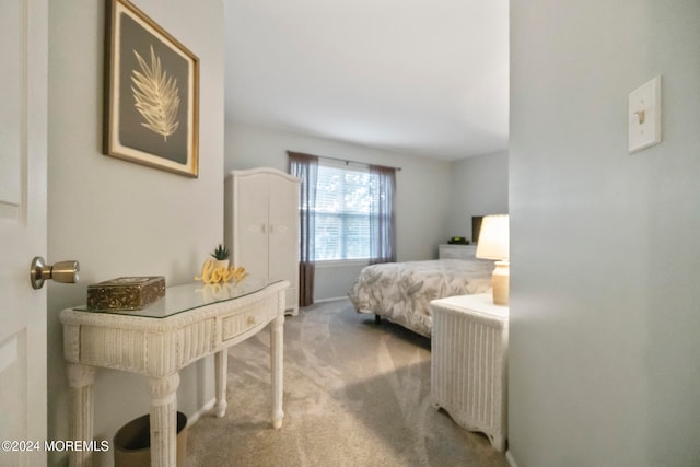 bedroom featuring light carpet