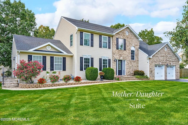 colonial inspired home with a front yard and a garage