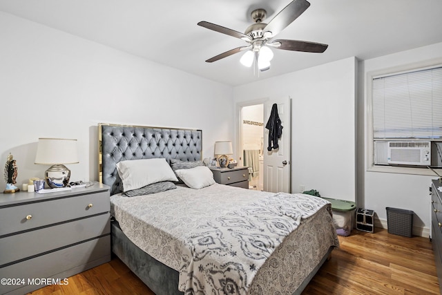 bedroom featuring cooling unit, dark wood-type flooring, and ceiling fan