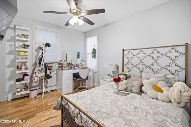 bedroom with light hardwood / wood-style flooring, cooling unit, and ceiling fan