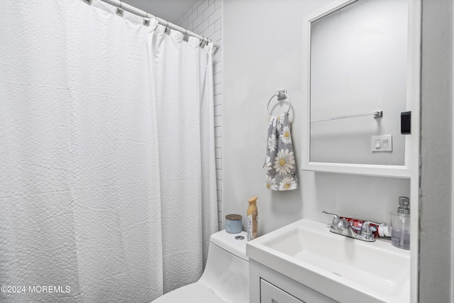 bathroom featuring vanity, toilet, and walk in shower