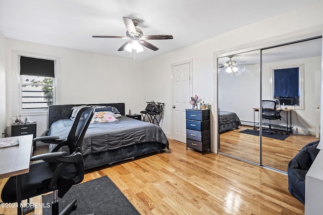 bedroom with baseboard heating, light wood-type flooring, and ceiling fan