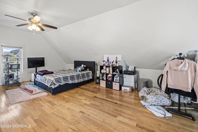 bedroom with ceiling fan, lofted ceiling, and light hardwood / wood-style floors