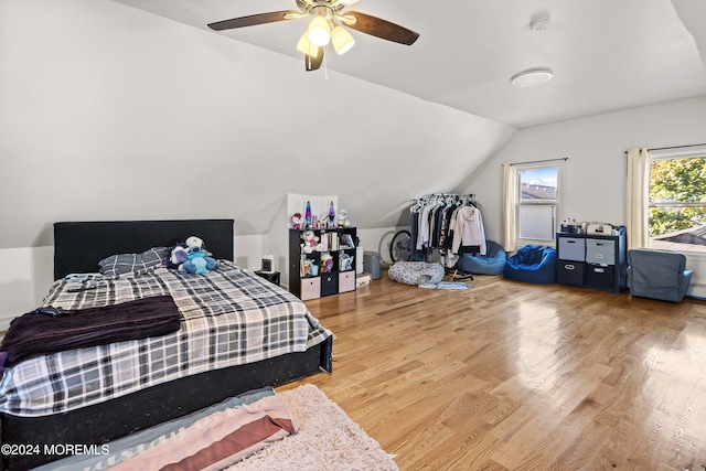 bedroom with vaulted ceiling, wood-type flooring, and ceiling fan