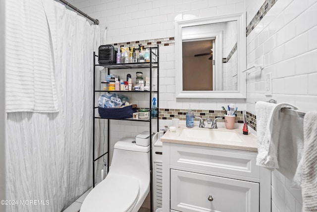 bathroom featuring backsplash, vanity, curtained shower, and toilet