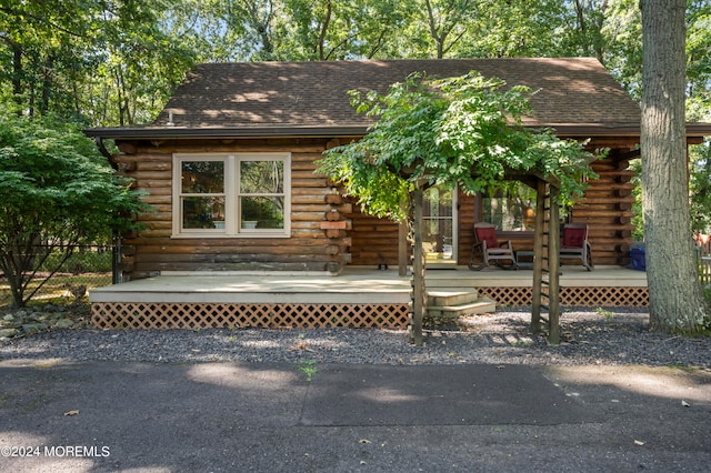 log-style house featuring covered porch