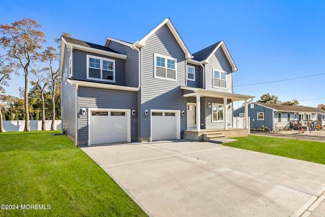 view of front of property featuring a front yard, covered porch, and a garage