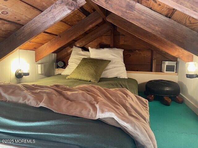 bedroom featuring lofted ceiling with beams, an AC wall unit, and wooden ceiling