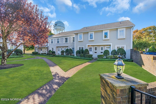 back of house with a lawn