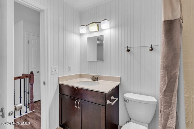 bathroom with toilet, curtained shower, hardwood / wood-style flooring, vanity, and crown molding