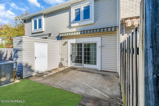 rear view of property featuring central air condition unit and a patio