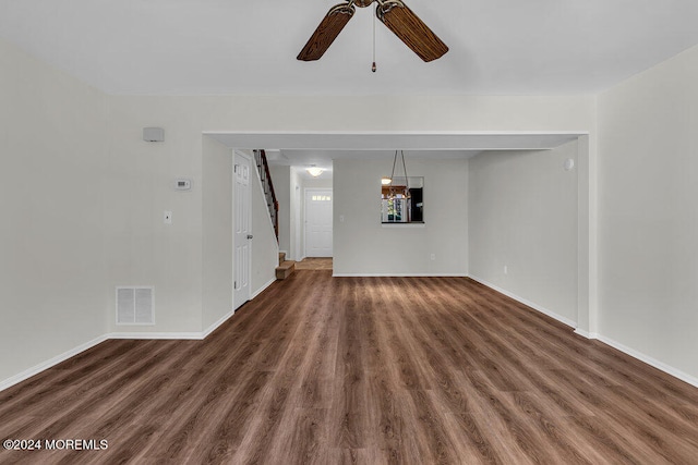 unfurnished living room featuring ceiling fan and dark hardwood / wood-style floors