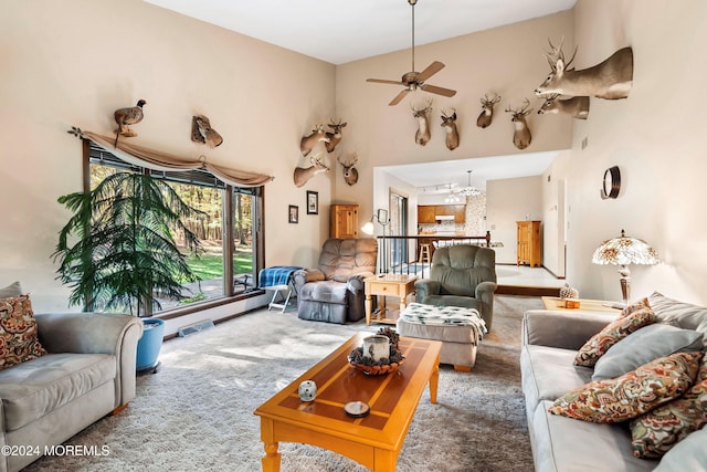 living room featuring carpet, ceiling fan with notable chandelier, and high vaulted ceiling