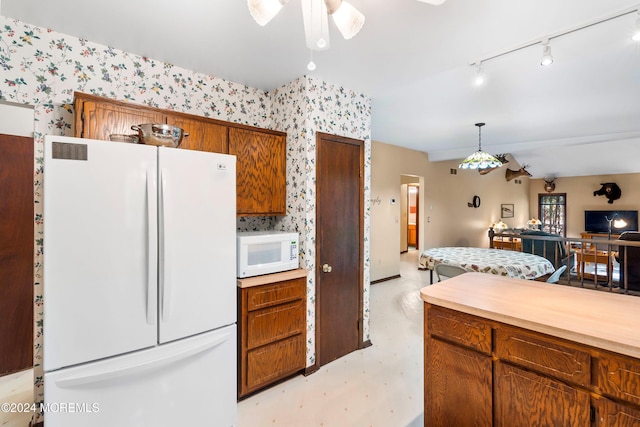 kitchen with rail lighting, pendant lighting, white appliances, and ceiling fan