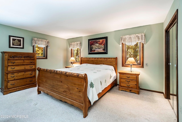 bedroom with light carpet and a closet