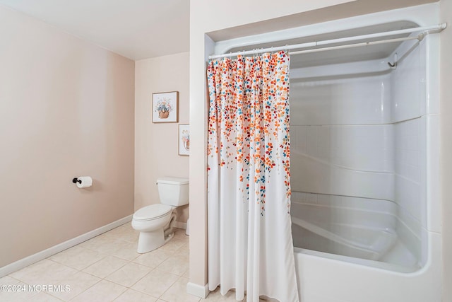 bathroom featuring tile patterned floors, shower / bath combo with shower curtain, and toilet