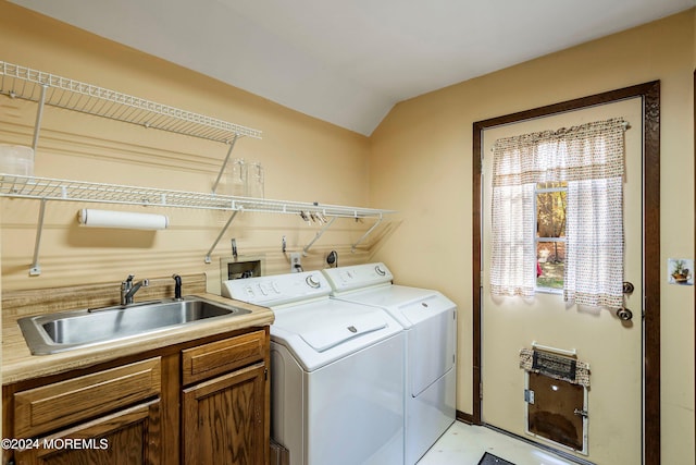 laundry room featuring cabinets, sink, and separate washer and dryer