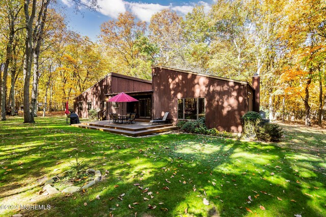 2 Filmore Dr, Millstone, NJ 08510 - back of house featuring a lawn, a wooden deck, and a chimney