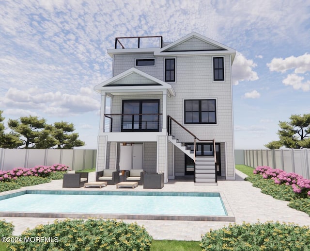 back of property with a balcony, a patio area, and a fenced in pool