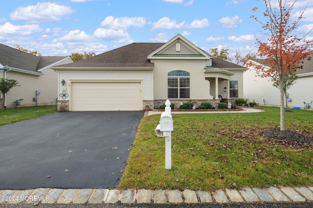 view of front of house featuring a front lawn and a garage