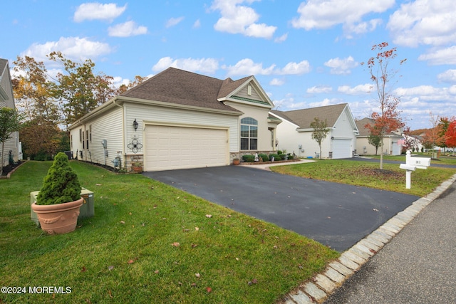 view of front of home with a front yard and a garage