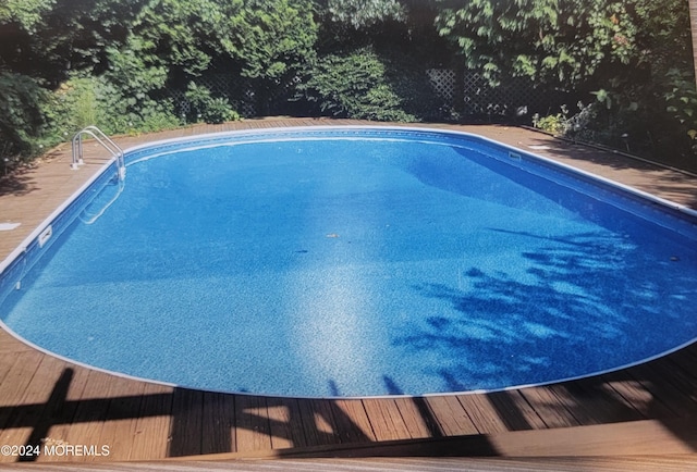 view of swimming pool featuring a deck