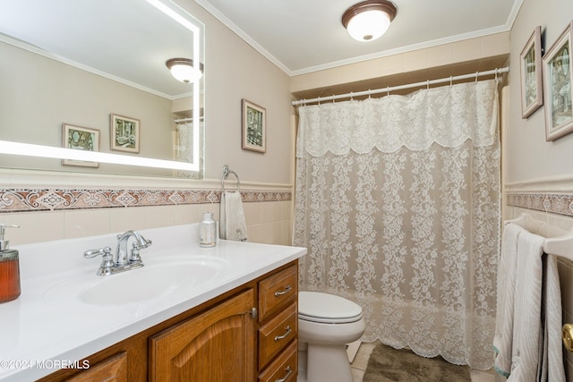 bathroom with tile patterned floors, toilet, vanity, tile walls, and ornamental molding