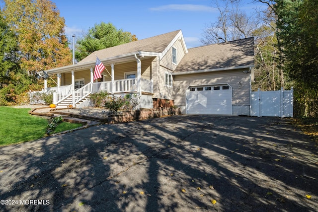 view of front of house featuring a porch and a garage