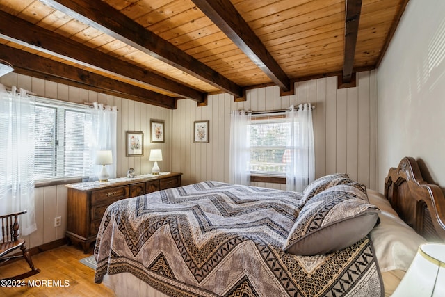 bedroom featuring multiple windows, wooden ceiling, and light wood-type flooring