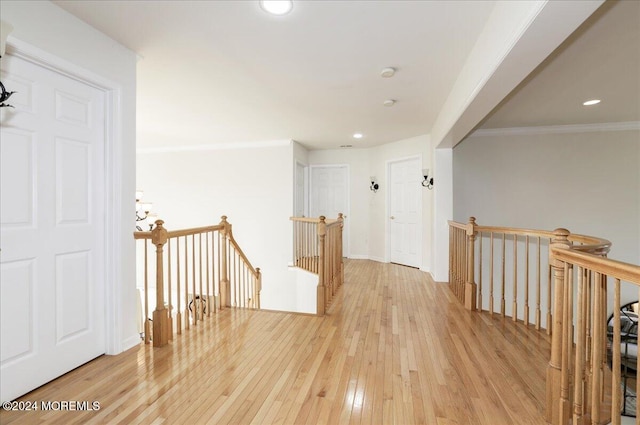 hall featuring wood-type flooring and crown molding