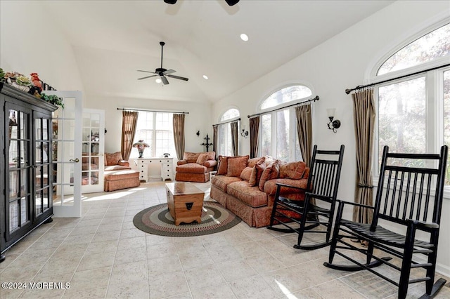 living room with ceiling fan and high vaulted ceiling