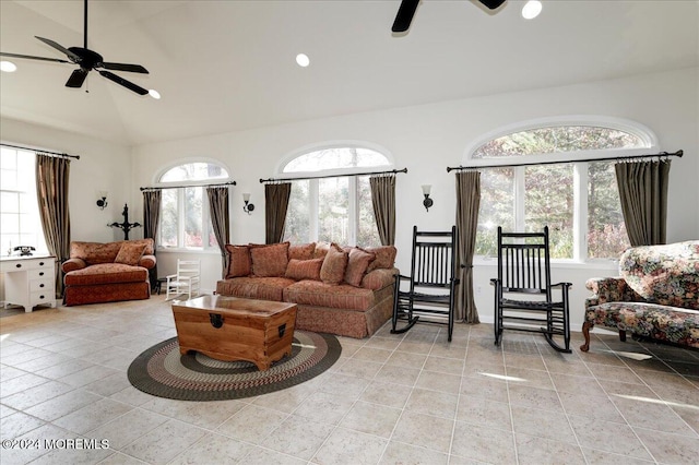 living room with lofted ceiling, ceiling fan, and light tile patterned floors